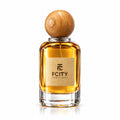 A bottle of FCITY Perfumes with amber-colored liquid, a square clear glass body, a textured beige label, and a round wooden cap, set against a plain white background.